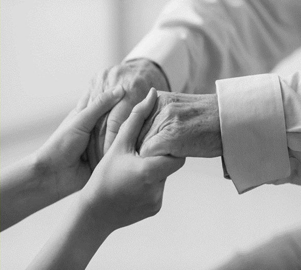 A person holding their hands in front of another person.